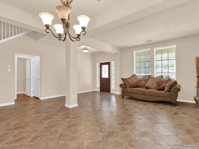 a view of an empty room with window and cabinet