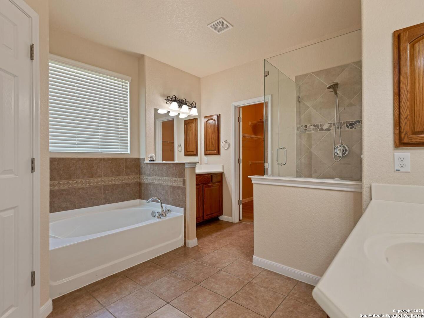 1008 Magellan Windcrest, TX 78239 - Photo 18 of 31 a bathroom with a bathtub and a shower