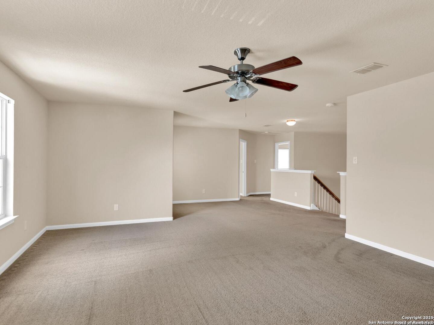 1008 Magellan Windcrest, TX 78239 - Photo 23 of 31 a view of an empty room and a ceiling fan