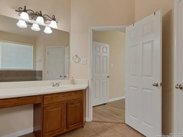 a backyard of a house with plants and tree