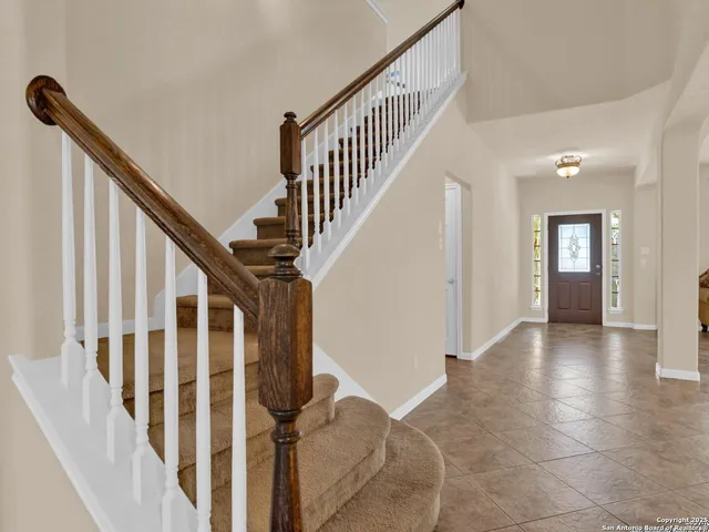 a view of an entryway with wooden floor and stairs