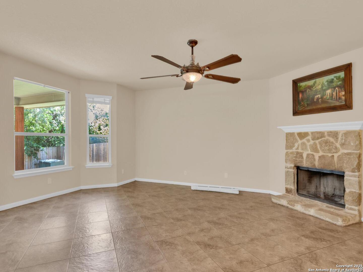 1008 Magellan Windcrest, TX 78239 - Photo 4 of 31 an empty room with windows and fireplace
