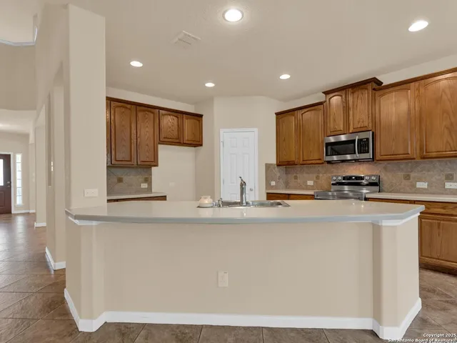 a view of an empty room with window and cabinet