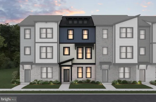 a front view of a residential apartment building with a yard