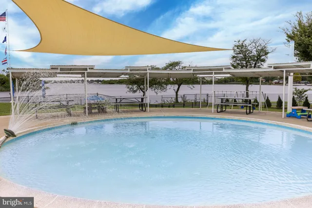 a view of a swimming pool with a lawn chairs