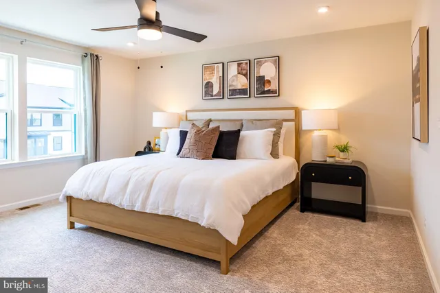 a bed sitting in a bedroom next to a window