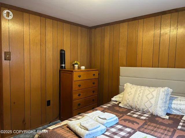 a bedroom with a bed and a dresser