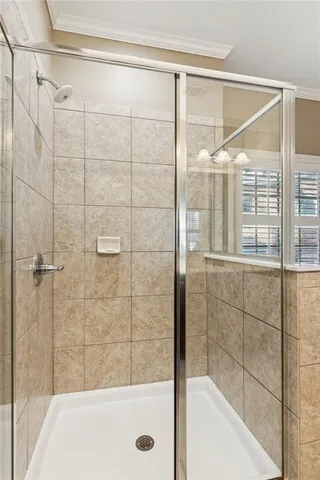 a front view of a building with lot of cars and trees