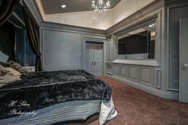 a bedroom with a bed and a television