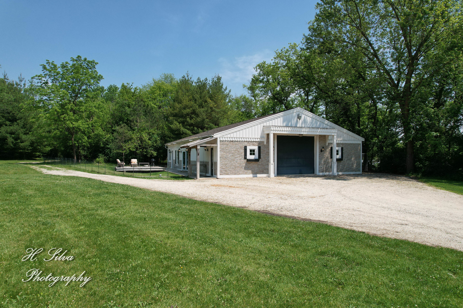 8106 Maple Street Marengo, IL 60152 - Photo 34 of 48 a front view of a house with a garden and trees