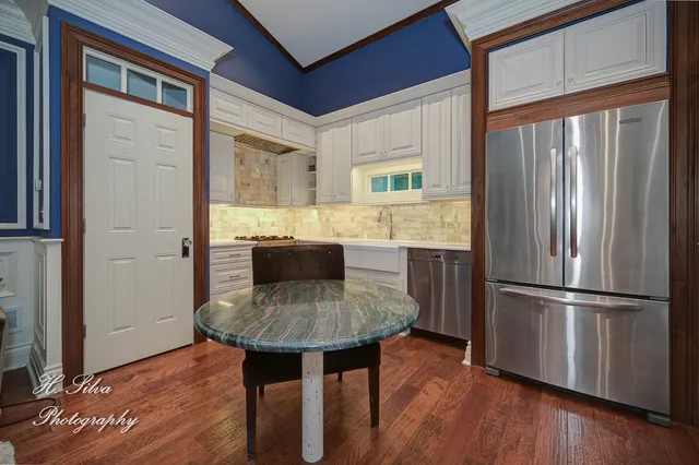 a kitchen with kitchen island a counter top space and stainless steel appliances