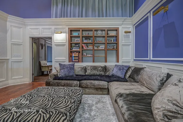 a living room with a couch and a bookshelf