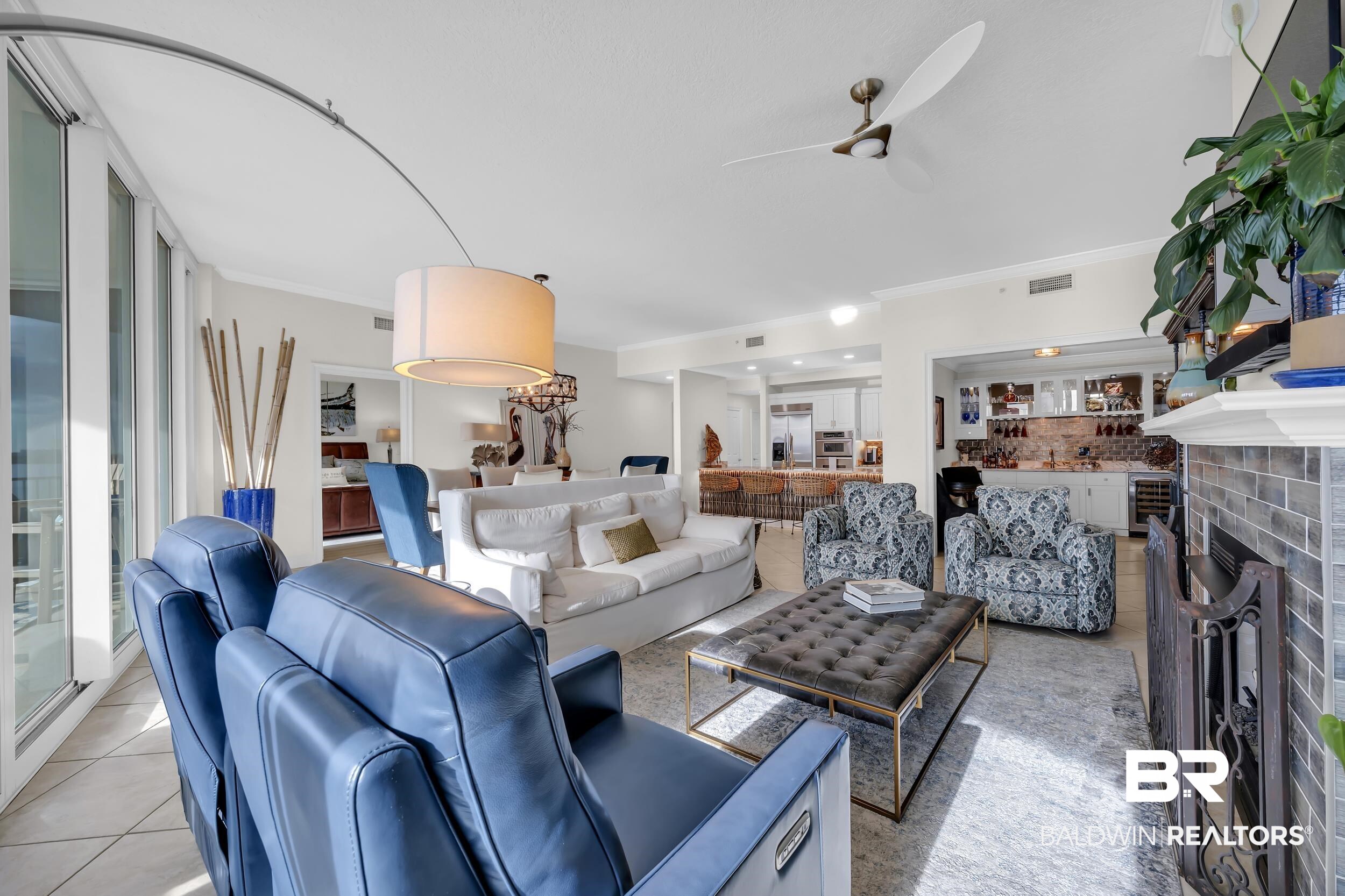 28250 Canal Road, Unit 307 Orange Beach, AL 36561 - Photo 28 of 56 Living room featuring crown molding, light tile patterned floors, a tile fireplace, beverage cooler, and ceiling fan