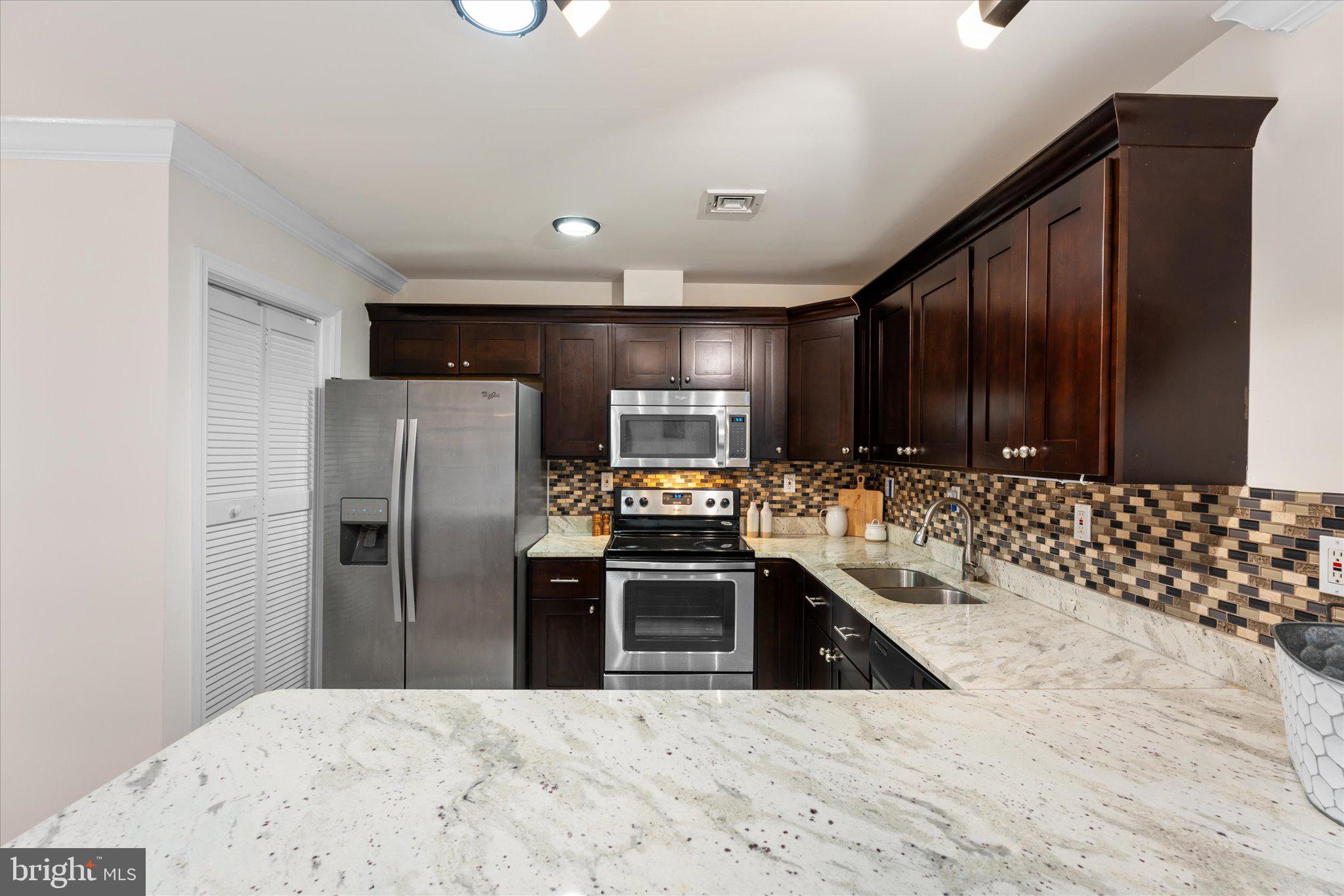 2231 Southgate Square Reston, VA 20191 - Photo 12 of 36 a kitchen with stainless steel appliances a refrigerator and a sink