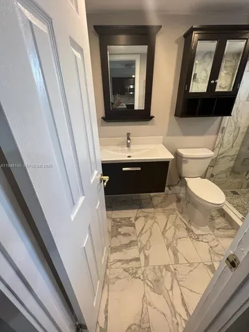 a bathroom with a bathtub sink and mirror