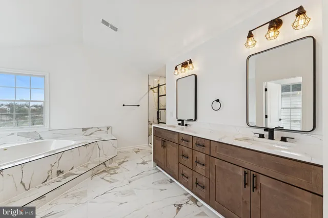 a bathroom with double sink and a mirror