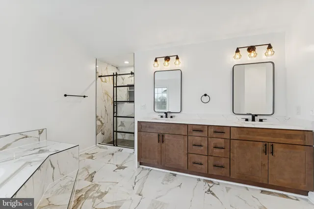 a spacious bathroom with a double vanity sink and a mirror