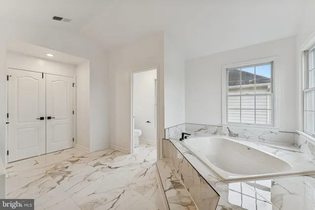 a bathroom with a bathtub and a sink