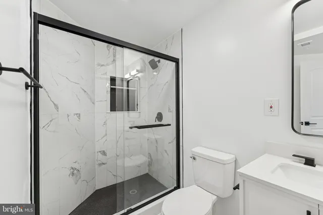 a bathroom with a toilet sink and shower
