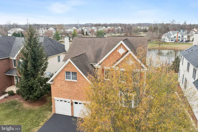 a aerial view of a house with a garden and lake view