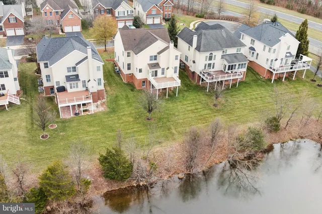 a view of residential houses with outdoor space and lake view