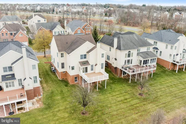 an aerial view of house with yard and ocean view