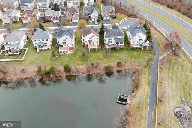 a view of a white house with a yard table and chairs