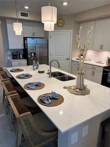 a kitchen with a dining table and chairs