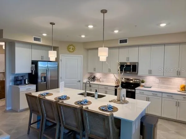 a kitchen with a stove a table and chairs