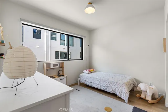 a bedroom with a bed and a lamp