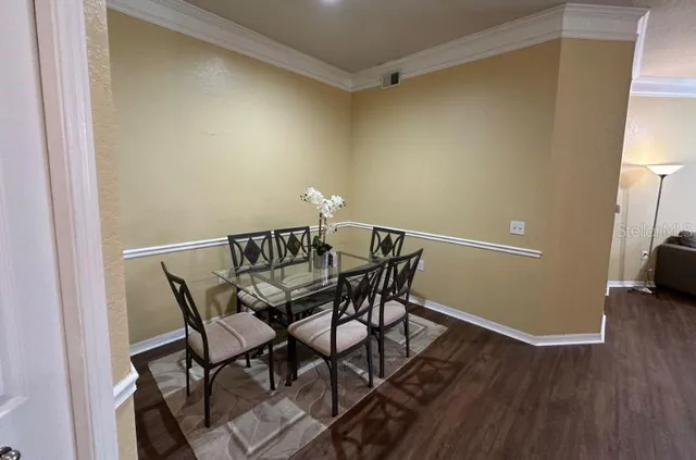 a view of a dining room with furniture and wooden floor