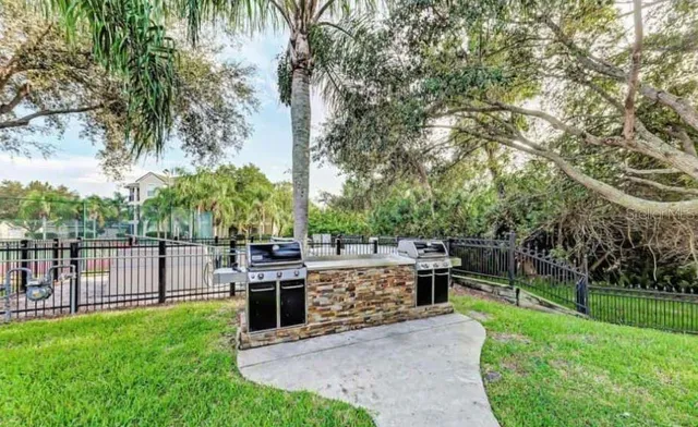a view of a house with a backyard and a patio