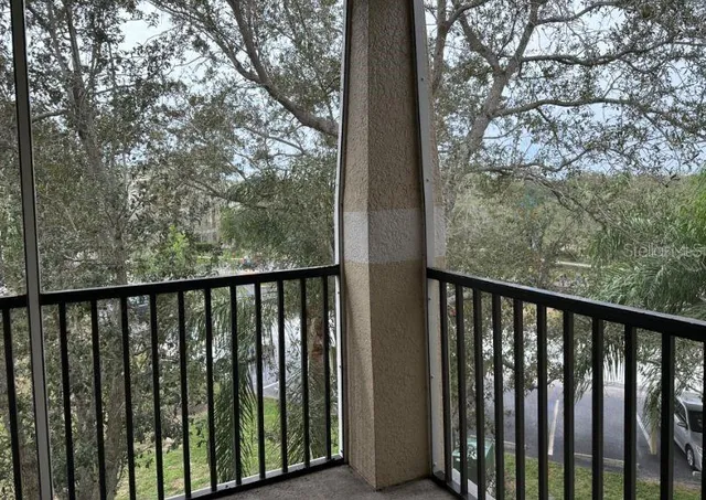 a view of a balcony with wooden fence and floor