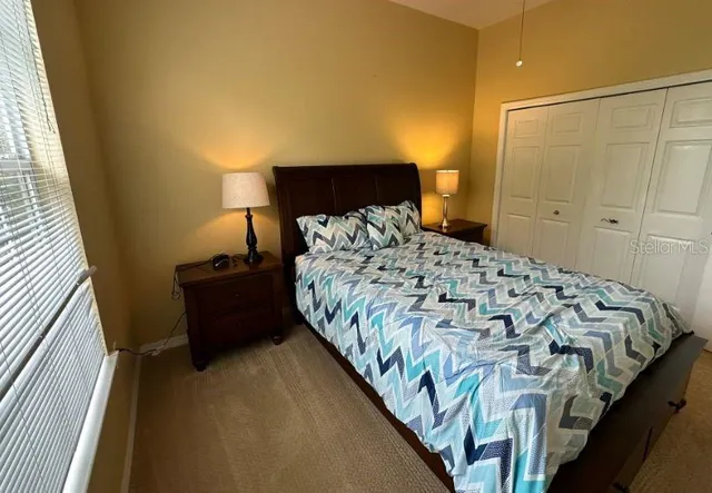 a bedroom with a bed and a night stand