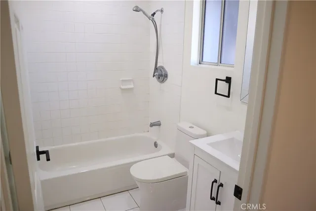 a bathroom with a granite countertop toilet and a shower