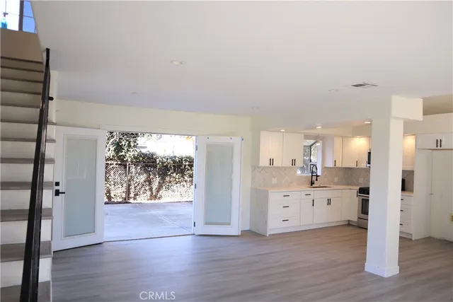a view of a kitchen with wooden floor and a kitchen