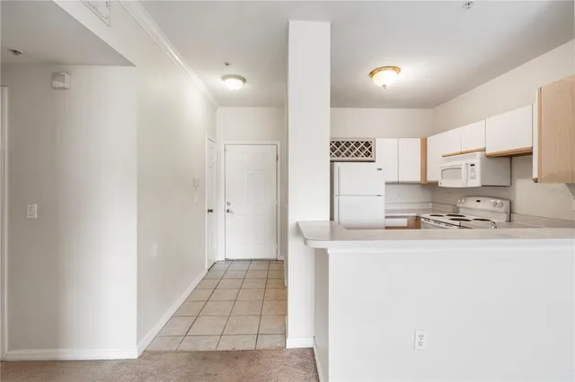 a kitchen with stainless steel appliances cabinets a sink and a refrigerator
