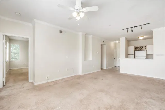 an empty room with fan and entrance