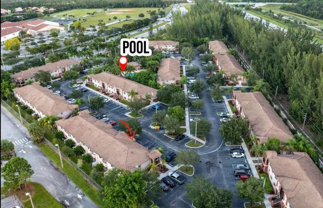 an aerial view of residential houses with outdoor space and street view