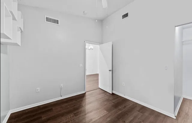 a view of an empty room with wooden floor