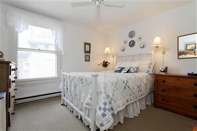 8 Cliff Road, Unit C Nantucket, MA 02554 - Photo 9 of 12 a bed room with a bed and a window