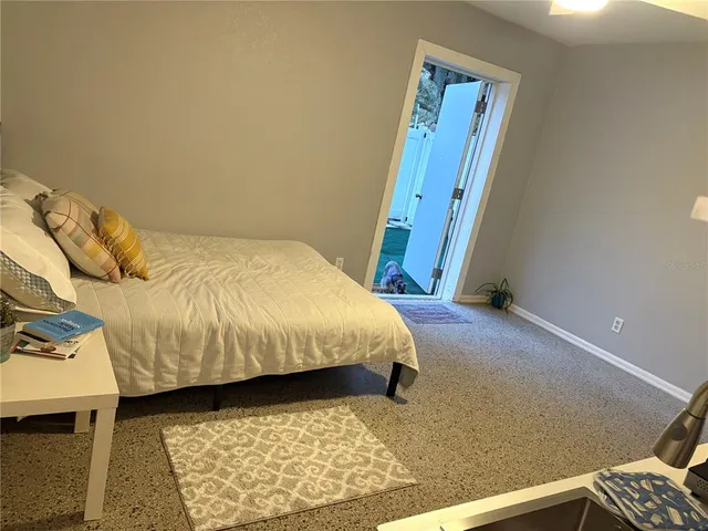 a bedroom with a bed and a rug