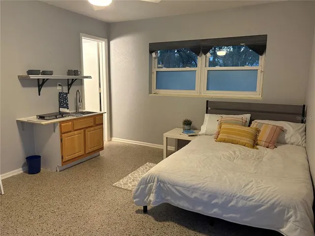 a bedroom with a bed and window