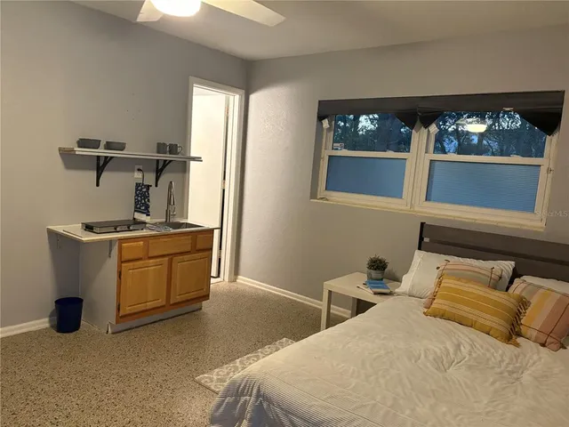 a bedroom with bed and window