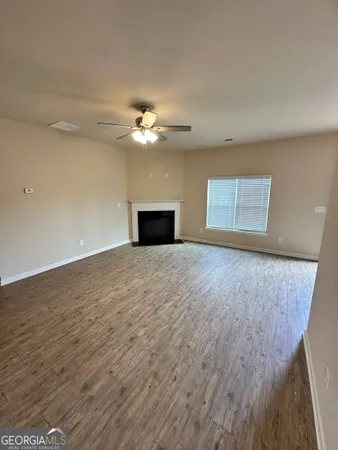 a view of empty room with a fireplace