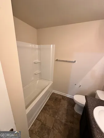 a bathroom with a bathtub and toilet