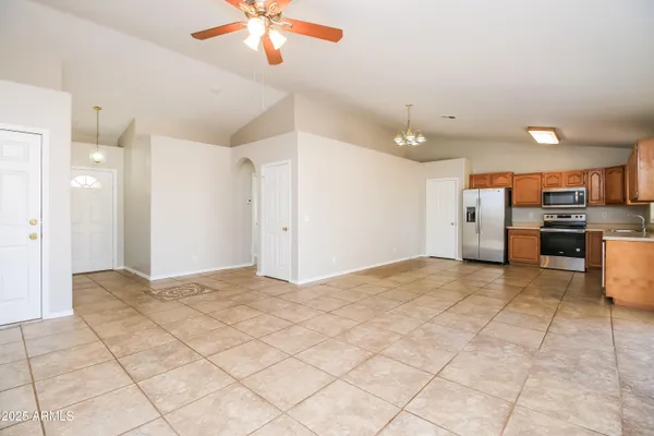 a view of a kitchen with furniture and stainless steel appliances