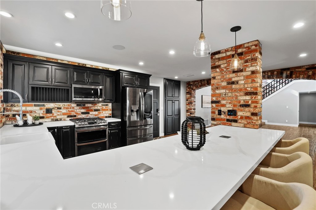 1810 Tanager Drive Costa Mesa, CA 92626 - Photo 15 of 55 a kitchen with stainless steel appliances kitchen island granite countertop a sink and stove