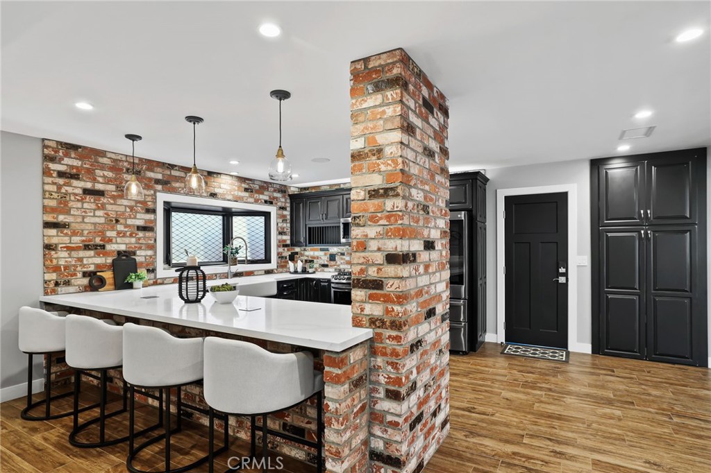 1810 Tanager Drive Costa Mesa, CA 92626 - Photo 17 of 55 a dinning room with furniture a flat screen tv and a kitchen view