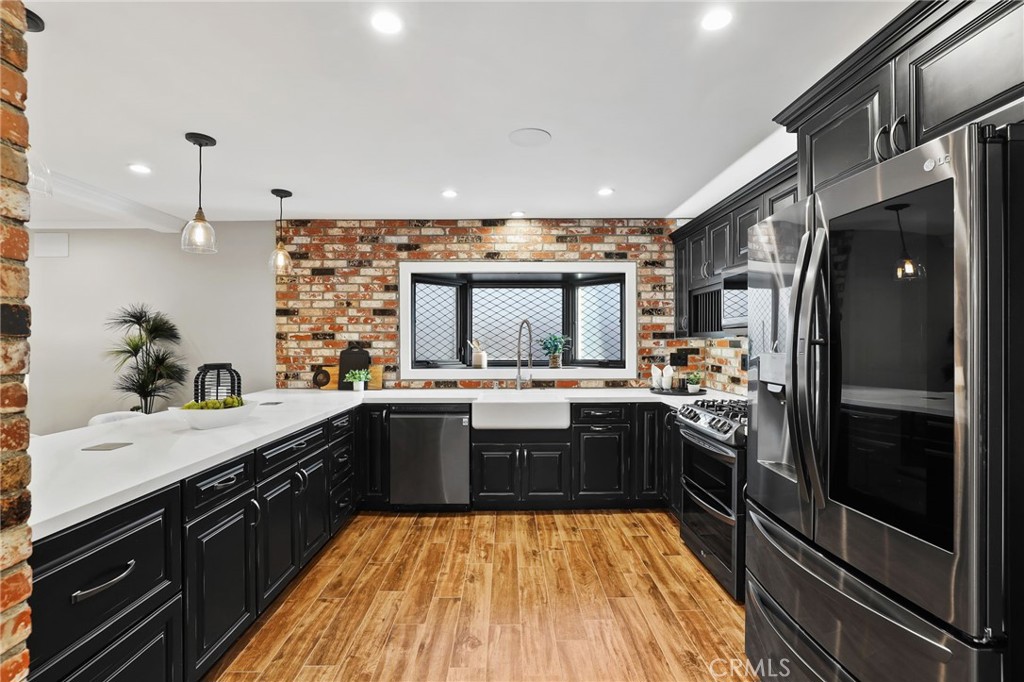 1810 Tanager Drive Costa Mesa, CA 92626 - Photo 18 of 55 a kitchen with a sink stainless steel appliances and cabinets